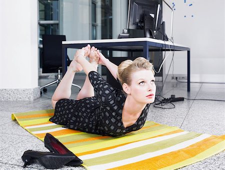 female yoga feet - Woman doing yoga in office Stock Photo - Premium Royalty-Free, Code: 614-00844350