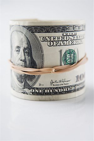 simsearch:614-00397700,k - Roll of hundred dollar bills Foto de stock - Sin royalties Premium, Código: 614-00843803