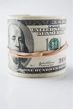 rolled money - Roll of hundred dollar bills Stock Photo - Premium Royalty-Free, Code: 614-00843803