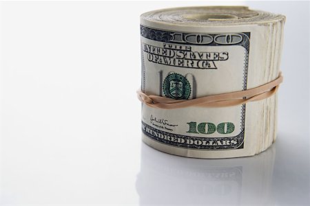 simsearch:614-00397700,k - Roll of hundred dollar bills Foto de stock - Sin royalties Premium, Código: 614-00843820