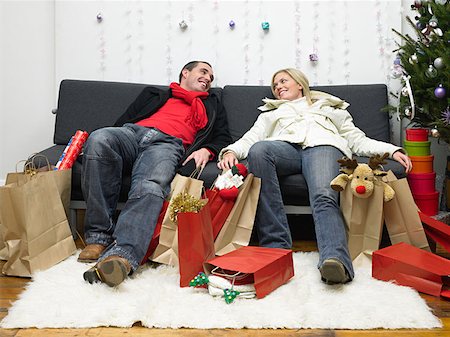 Couple exhausted after christmas shopping Stock Photo - Premium Royalty-Free, Code: 614-00892863