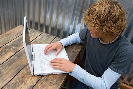 simsearch:640-05761338,k - Teenage boy working on a laptop computer Stock Photo - Premium Royalty-Free, Code: 614-00893348