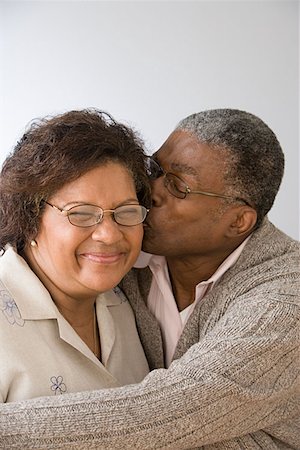 funny intimacy - Man kissing wife on the cheek Stock Photo - Premium Royalty-Free, Code: 614-00914023