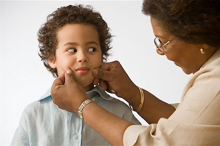 Grandmother pinching grandson's cheeks Stock Photo - Premium Royalty-Free, Code: 614-00914073