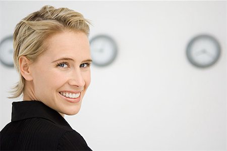 simsearch:628-02198065,k - Businesswoman stood in front of three wall clocks Stock Photo - Premium Royalty-Free, Code: 614-00913031