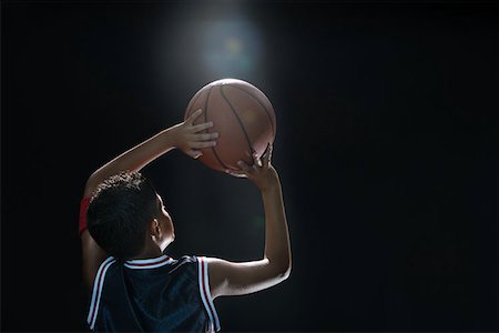 fitness future - Illuminated boy with basketball Stock Photo - Premium Royalty-Free, Code: 614-00913462