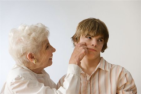 smiling and sulking - Woman grabbing grandson's cheek Stock Photo - Premium Royalty-Free, Code: 614-00913932