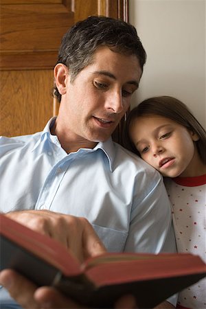 pictures of people reading the bible - Father reading bible to daughter Stock Photo - Premium Royalty-Free, Code: 614-00968042