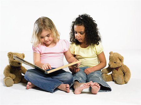 Girls looking at a picture book Stock Photo - Premium Royalty-Free, Code: 614-01028669