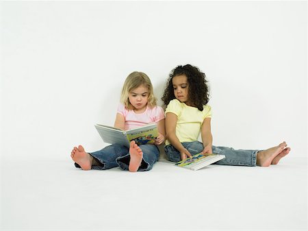 Girls looking at picture books Stock Photo - Premium Royalty-Free, Code: 614-01028702