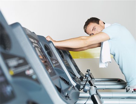 exhausted gym - Man on treadmill in health club Stock Photo - Premium Royalty-Free, Code: 614-01069260