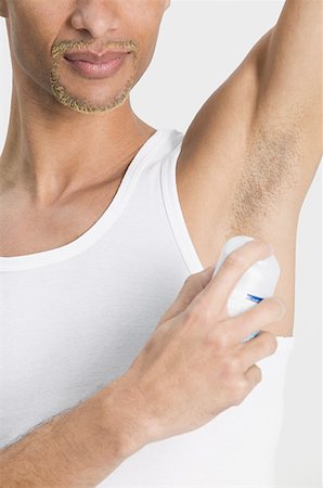 Man applying deodorant Stock Photo - Premium Royalty-Free, Code: 614-01088174
