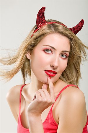 Woman wearing a devil costume Stock Photo - Premium Royalty-Free, Code: 614-01088312