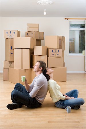 Couple taking a break from unpacking Stock Photo - Premium Royalty-Free, Code: 614-01088435