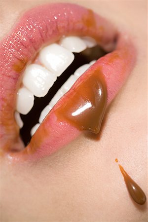 Woman with chocolate sauce on her lips Stock Photo - Premium Royalty-Free, Code: 614-01088585