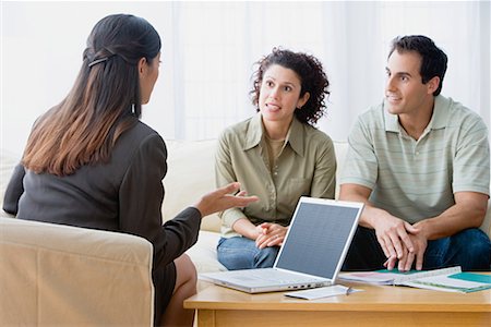 Couple talking to a financial advisor Stock Photo - Premium Royalty-Free, Code: 614-01178548