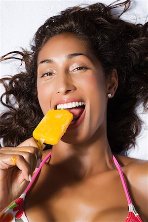 Woman eating ice lolly Stock Photo - Premium Royalty-Free, Code: 614-01178943