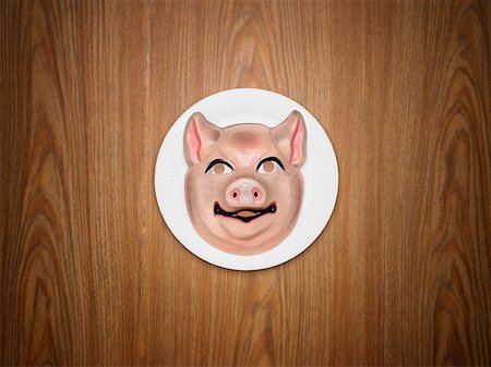 Pig mask on a plate Stock Photo - Premium Royalty-Free, Code: 614-01170900