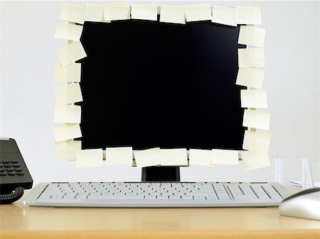 Adhesive notes covering edge of computer monitor Stock Photo - Premium Royalty-Free, Code: 614-01170916