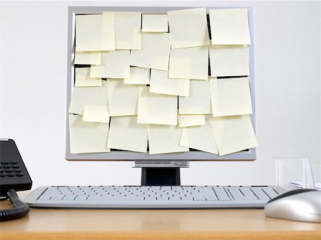 Computer monitor covered in adhesive notes Stock Photo - Premium Royalty-Free, Code: 614-01170913