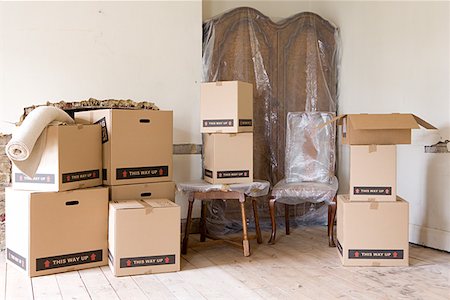 Cardboard boxes and furniture in room Stock Photo - Premium Royalty-Free, Code: 614-01170983