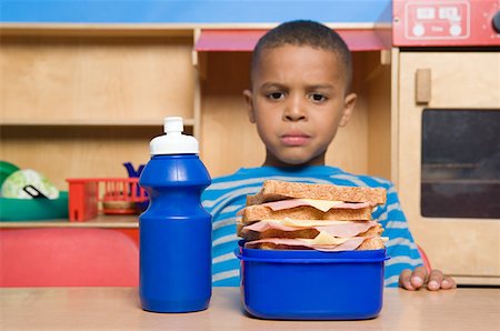 school lunch box - Boy looking at lunch box Stock Photo - Premium Royalty-Free, Code: 614-01171283