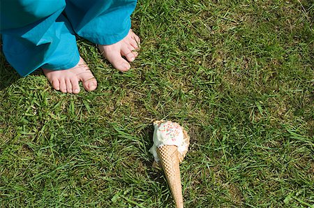 Feet of child and dropped ice cream Stock Photo - Premium Royalty-Free, Code: 614-01171389