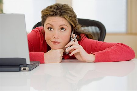 Office worker on cellphone Stock Photo - Premium Royalty-Free, Code: 614-01238746