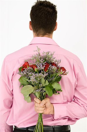 Man holding bunch of flowers Stock Photo - Premium Royalty-Free, Code: 614-01268093