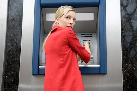 Woman using cash machine Stock Photo - Premium Royalty-Free, Code: 614-01433301