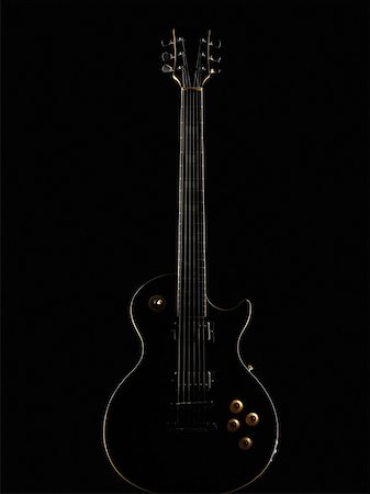 A black coloured electric guitar with black background Stock Photos - Page  1 : Masterfile