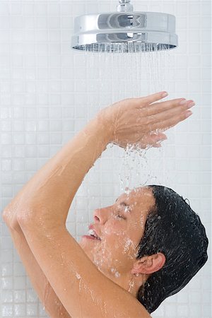 Woman showering Stock Photo - Premium Royalty-Free, Code: 614-01487301