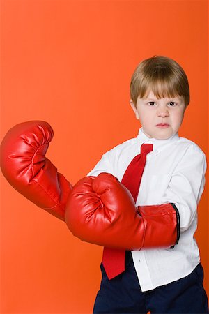 Boy wearing boxing gloves Stock Photo - Premium Royalty-Free, Code: 614-01559138