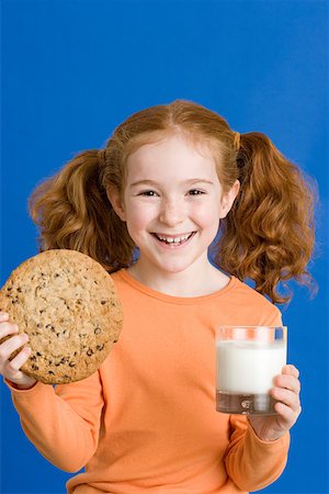 Girl with milk and cookie Stock Photo - Premium Royalty-Free, Code: 614-01559165