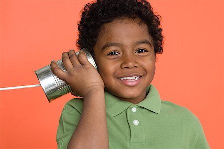 Boy with tin can telephone Stock Photo - Premium Royalty-Free, Code: 614-01559178