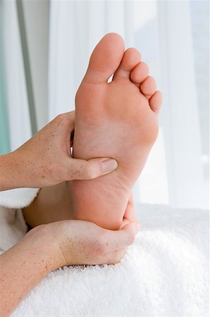 Woman having her foot massaged Stock Photo - Premium Royalty-Free, Code: 614-01560212
