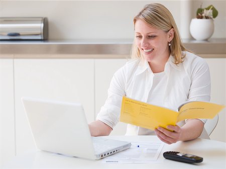 Woman making an insurance claim on the internet Stock Photo - Premium Royalty-Free, Code: 614-01623524