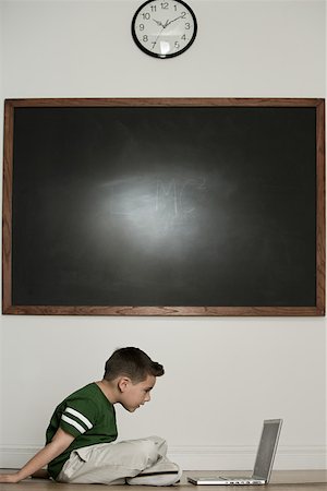 Boy looking at laptop Stock Photo - Premium Royalty-Free, Code: 614-01636082