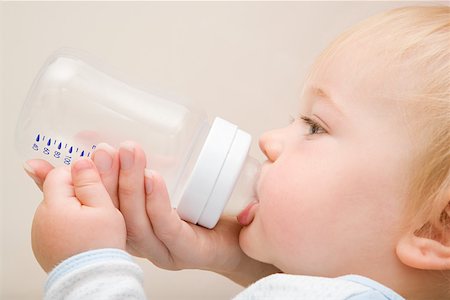 Baby boy drinking from bottle Stock Photo - Premium Royalty-Free, Code: 614-01699799