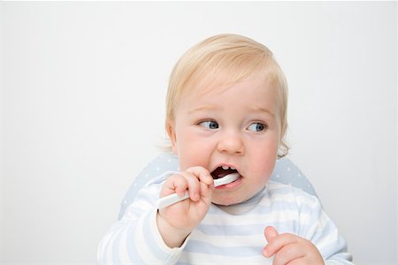 A baby boy brushing his teeth Stock Photo - Premium Royalty-Free, Code: 614-01699820