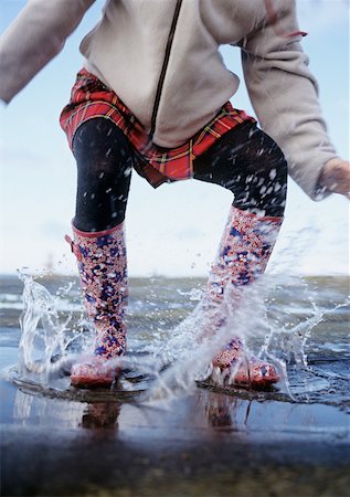 rain boots jump - Person splashing Stock Photo - Premium Royalty-Free, Code: 614-01755878