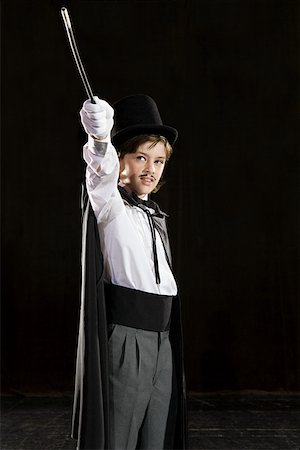 A boy pretending to be a magician Stock Photo - Premium Royalty-Free, Code: 614-01757730