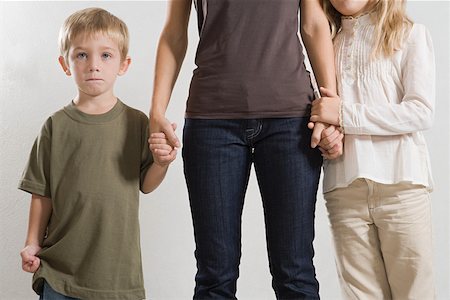 sad boy for mom - Children holding their mothers hand Stock Photo - Premium Royalty-Free, Code: 614-01758387