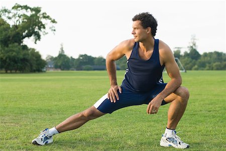 Man stretching in park Stock Photo - Premium Royalty-Free, Code: 614-01819679