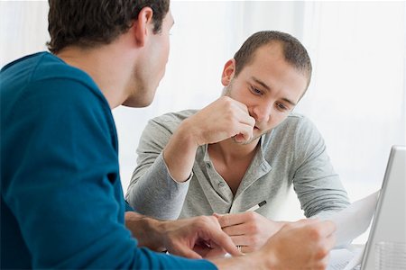 personal finance - Gay couple doing finances Stock Photo - Premium Royalty-Free, Code: 614-01820185