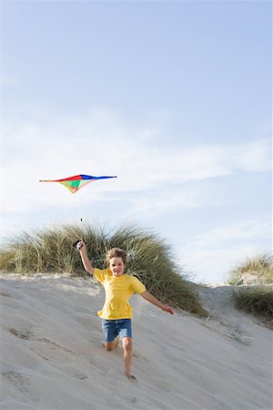 running sand dune - A boy flying a kite Stock Photo - Premium Royalty-Free, Code: 614-01820281