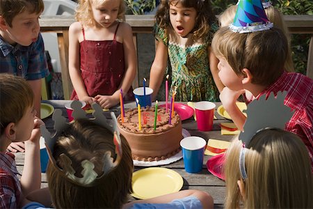 Children blowing out birthday candles Stock Photo - Premium Royalty-Free, Code: 614-01821419