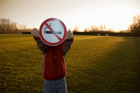 Boy holding a no smoking sign Stock Photo - Premium Royalty-Free, Code: 614-01868672