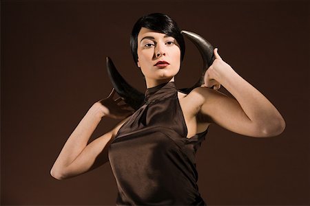 Young woman with animal horn Stock Photo - Premium Royalty-Free, Code: 614-02003820