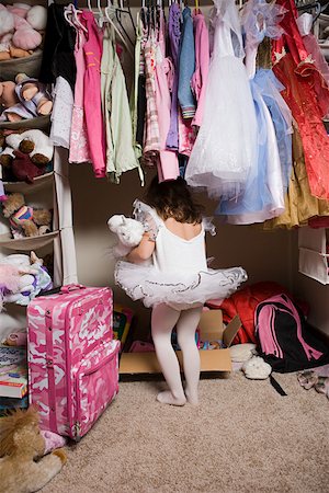 Girl in tutu looking in closet Stock Photo - Premium Royalty-Free, Code: 614-02049689